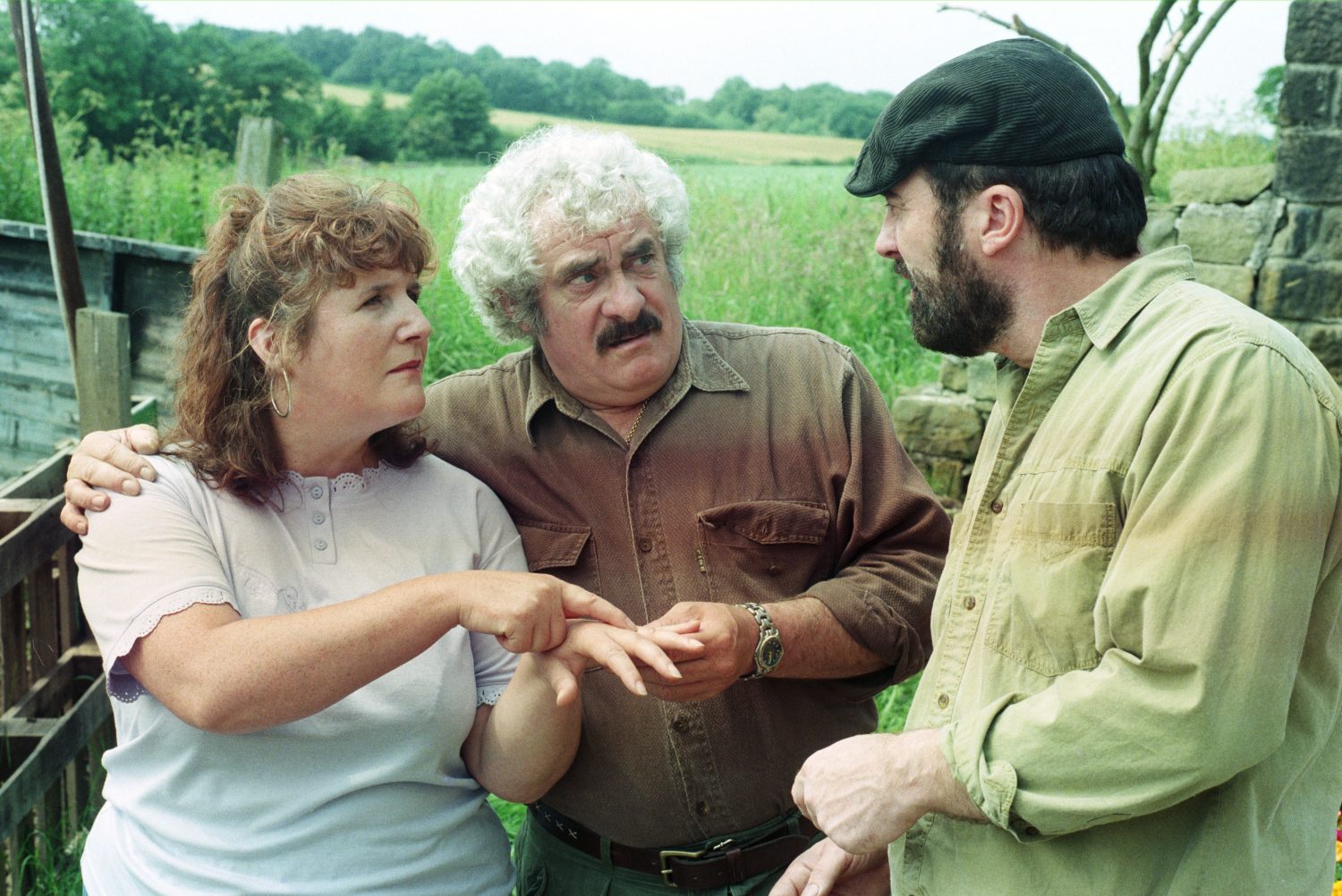 Lisa shows off her engagement ring to Zak as Albert puts his arm around her in Emmerdale