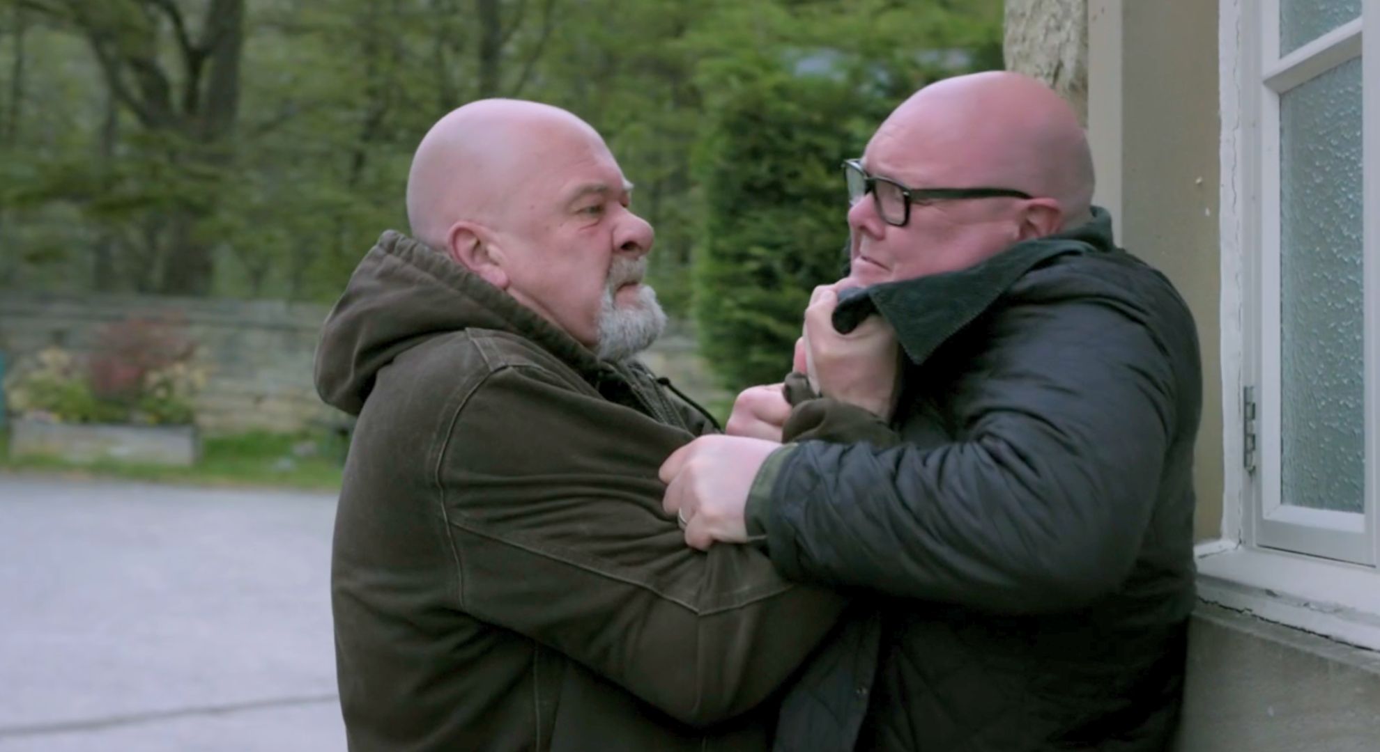Bear pinned Paddy against a wall raging at him in Emmerdale (Credit: ITV)