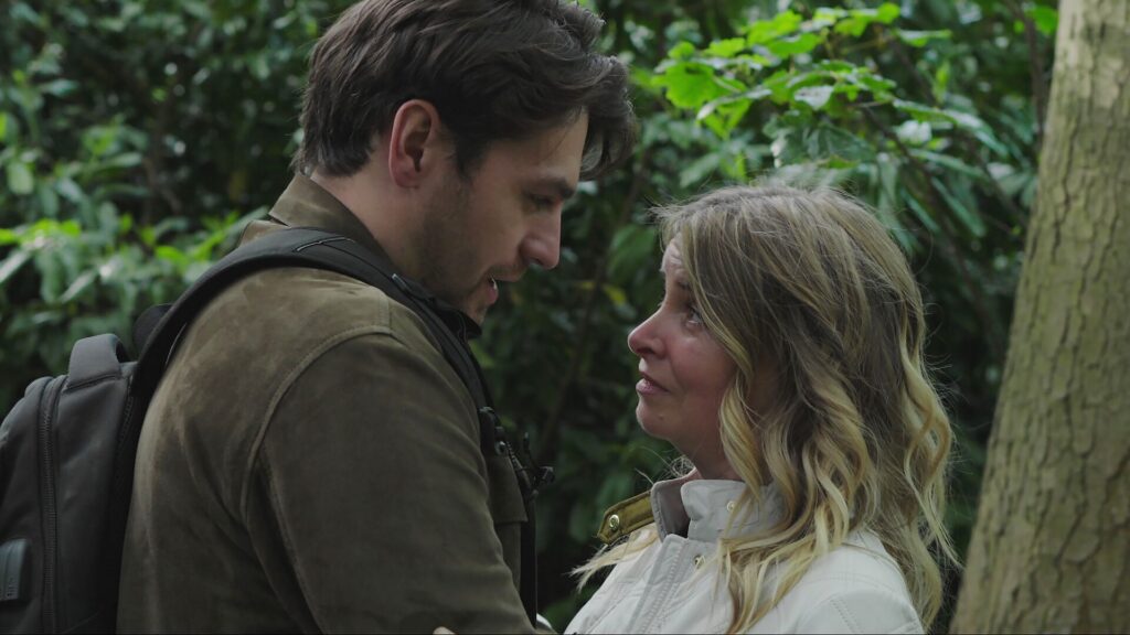 Charity and Mack talk in the woods in Emmerdale