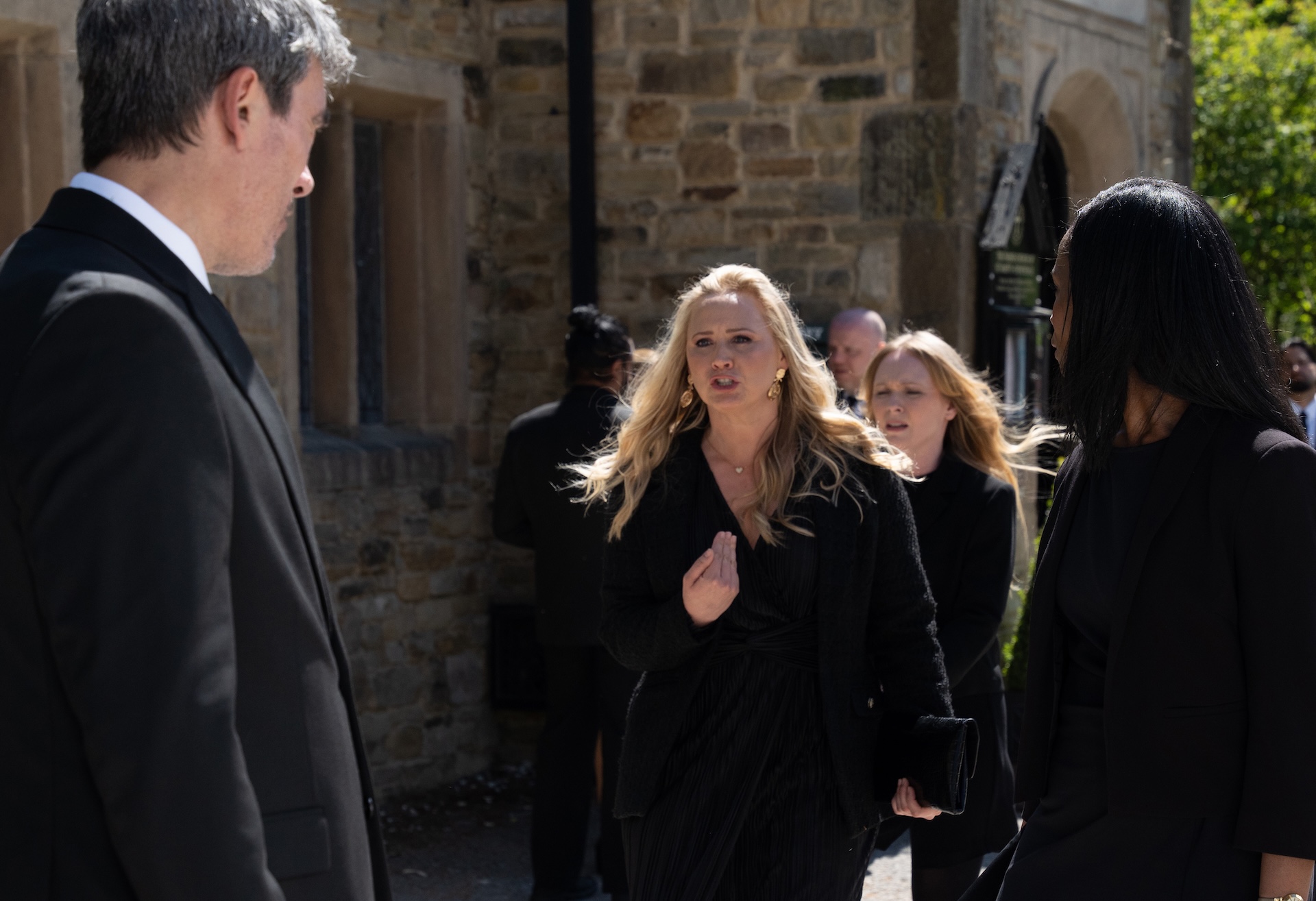 Tracy and Cain argue outside the church