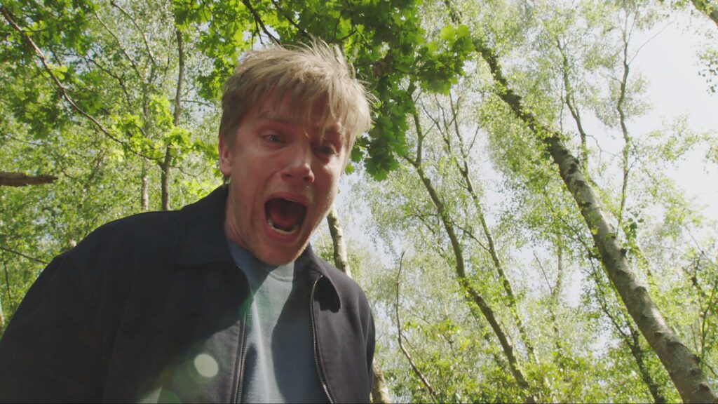 Robert screams as John takes Aaron over the edge of the gorge (Credit: ITV)