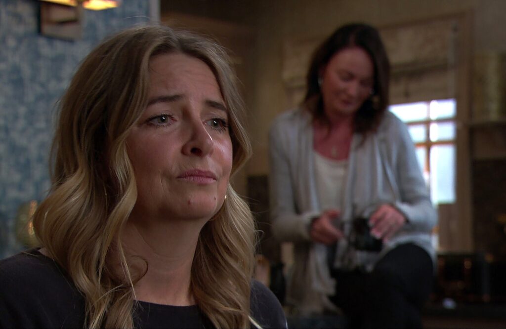 Charity looks sad while talking to Chas in Emmerdale