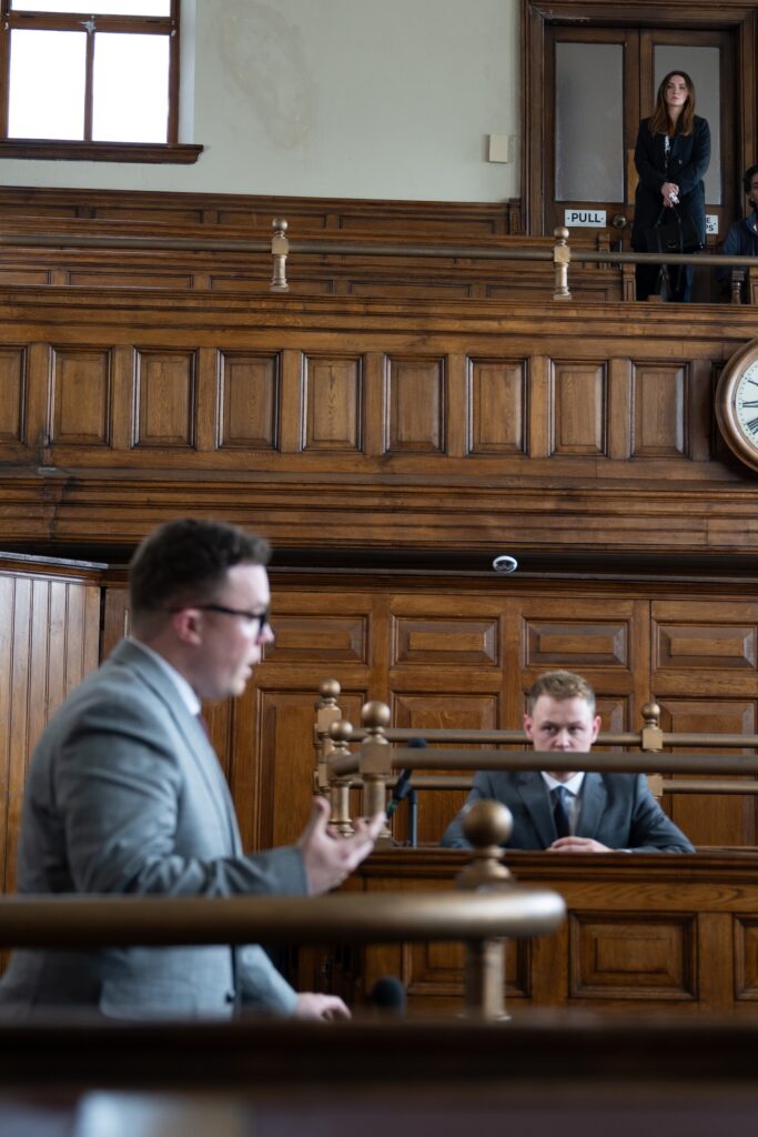 Gabby watches Vinny on the stand