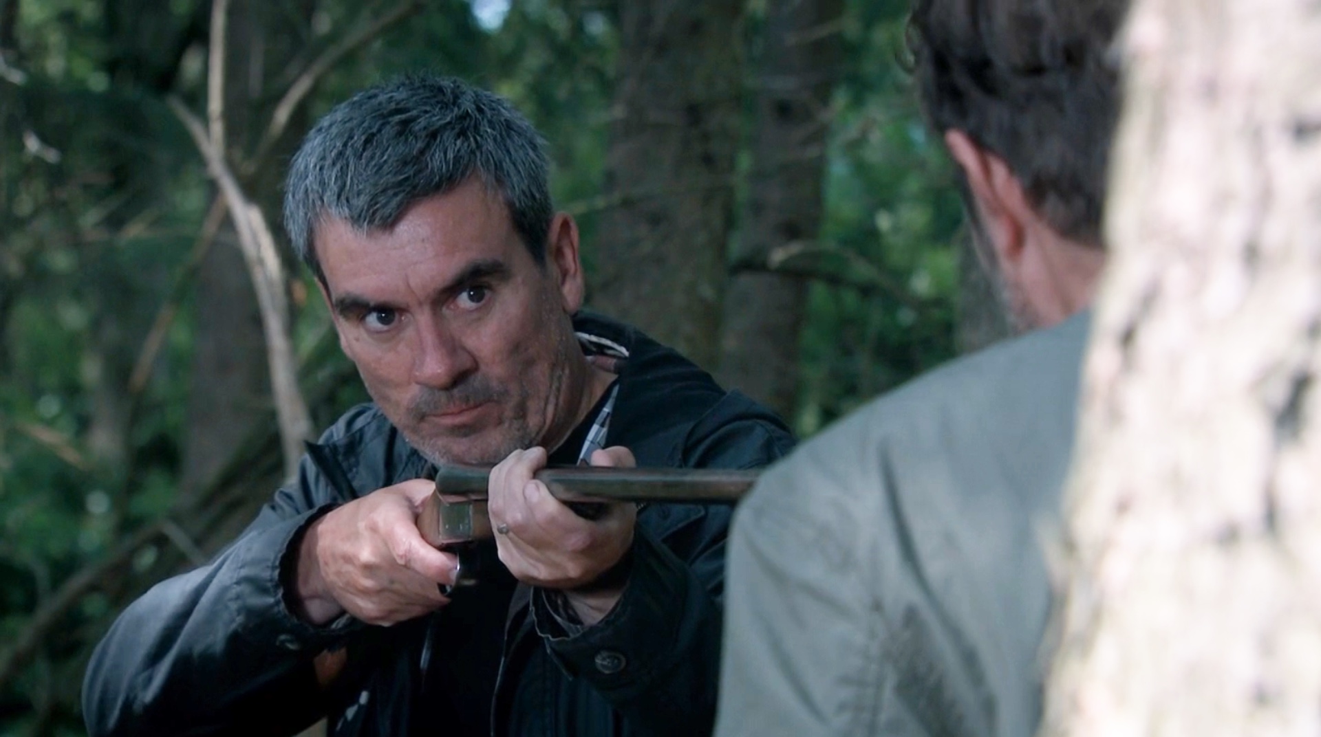 Cain pointing gun at John in Emmerdale