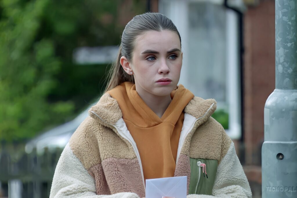 April clutches an envelope