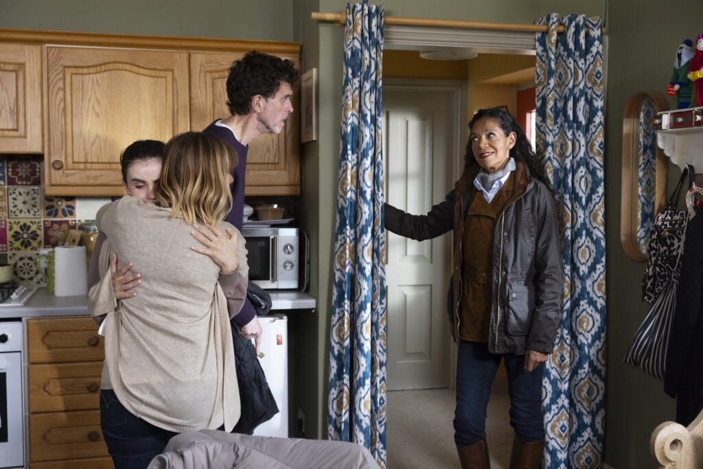 Celia stands in the door of Smithy