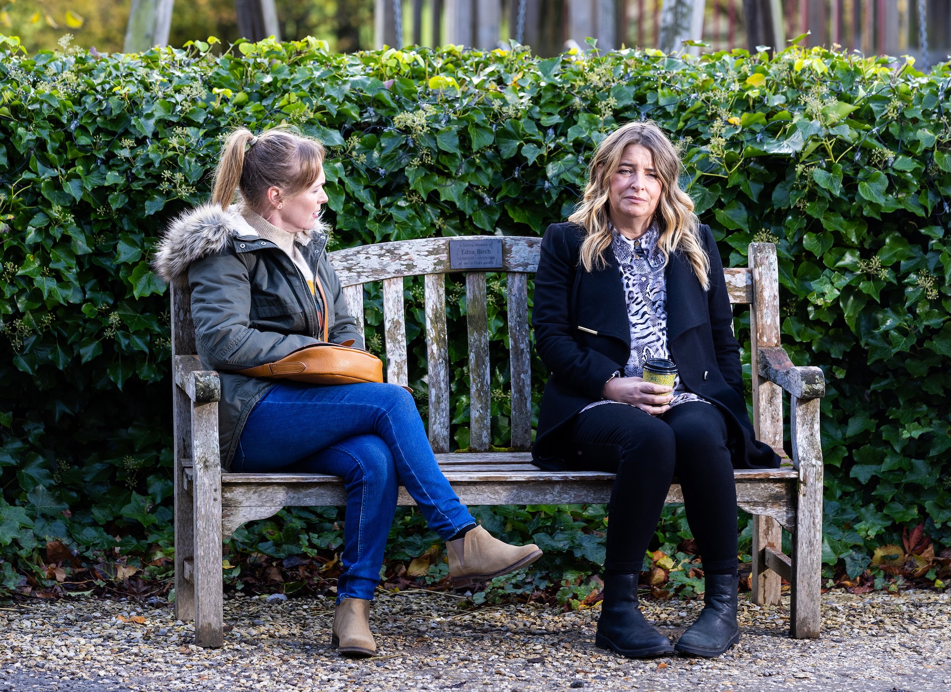 Vanessa and Charity talk on a bench