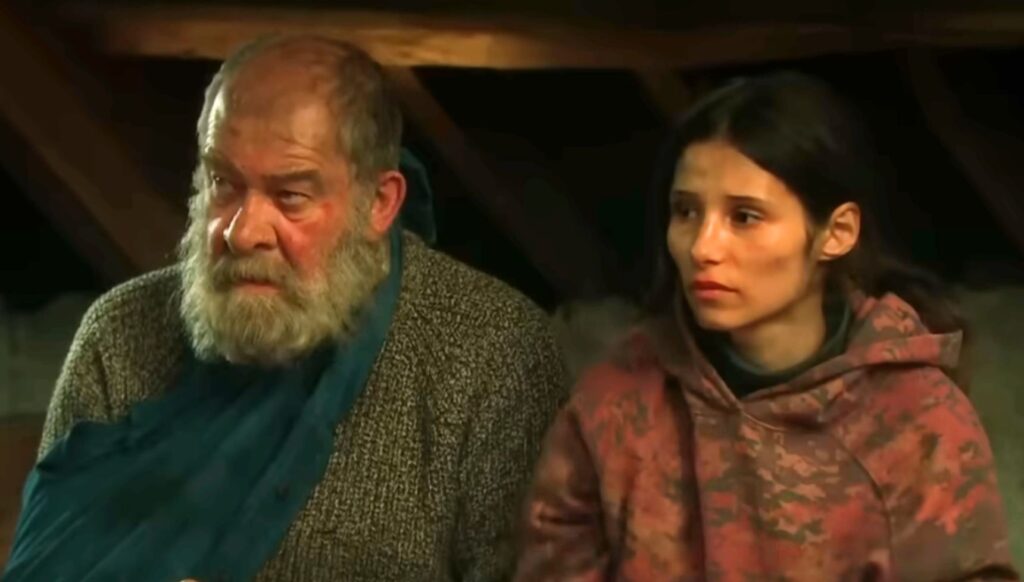 Bear and Anya sit together in Emmerdale