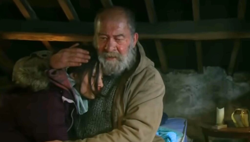 Bear cradling Anya in Emmerdale