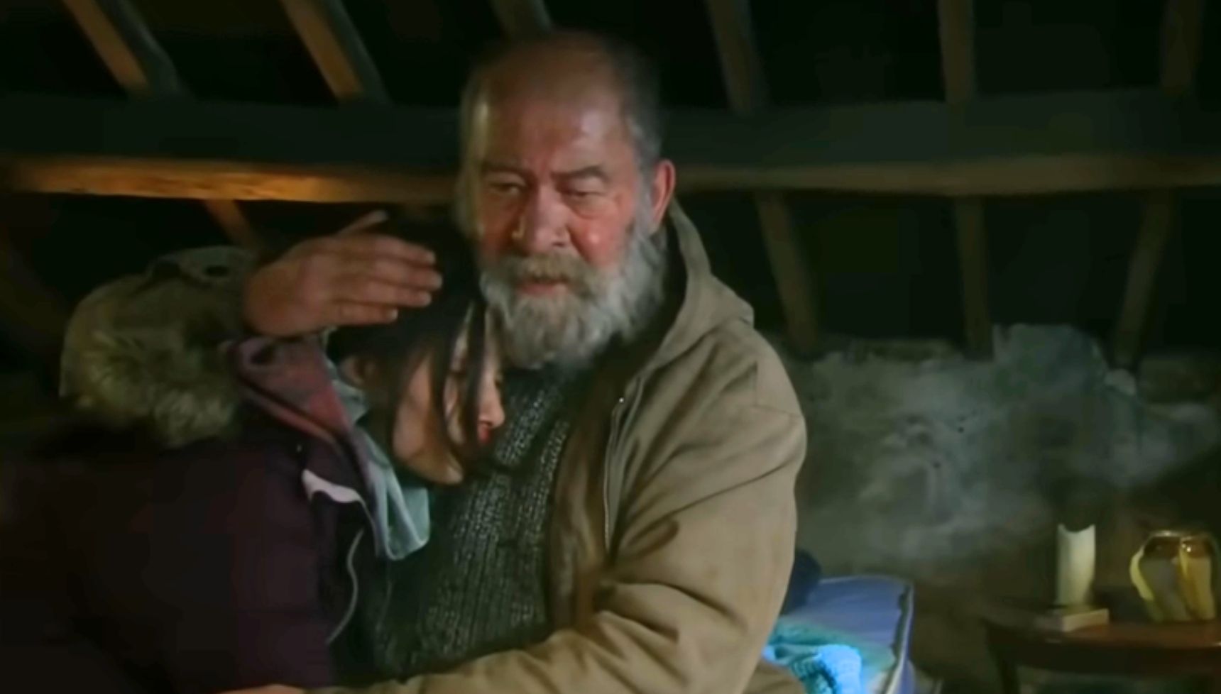 Bear cradling Anya in Emmerdale