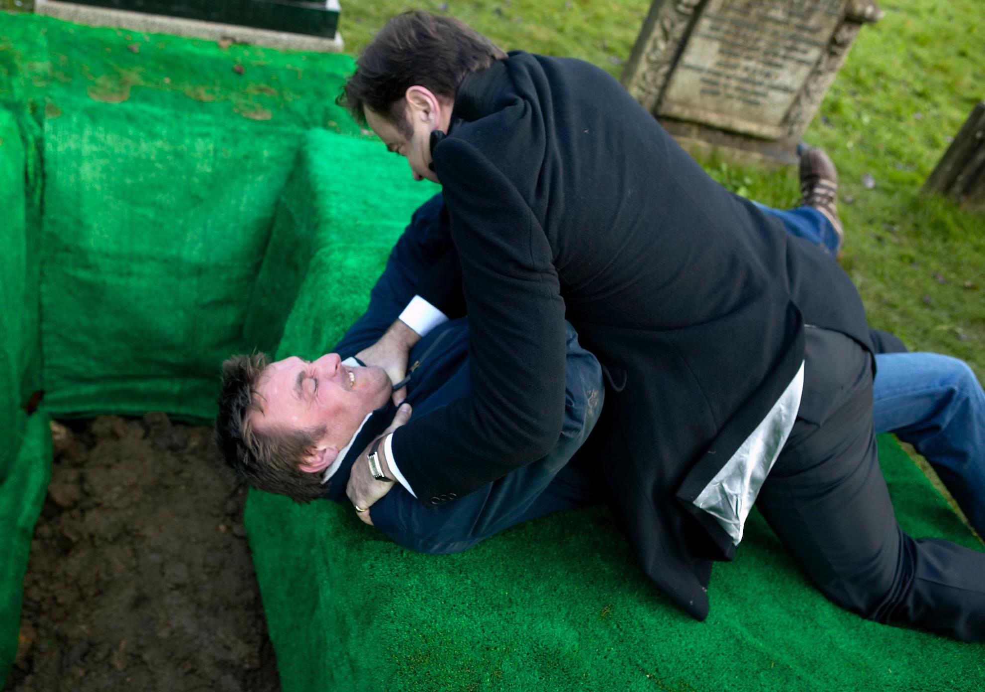 Jimmy and Gray wrestle on Rosemary's grave
