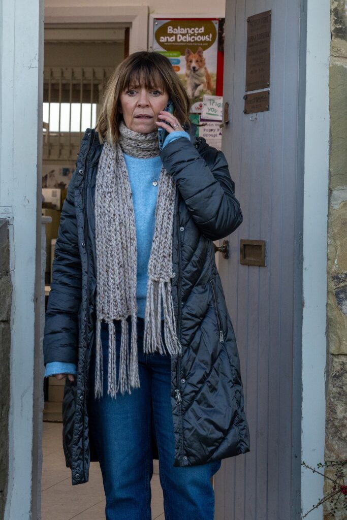 Rhona looks worried as she makes a phone call