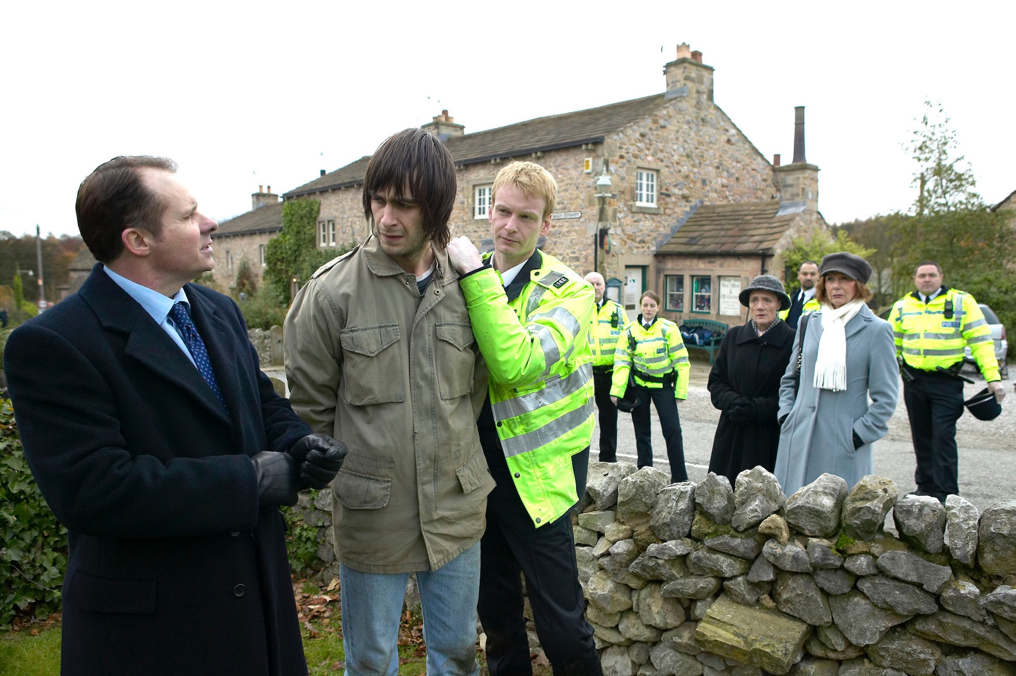 Eli is arrested as a worried Lily looks on 