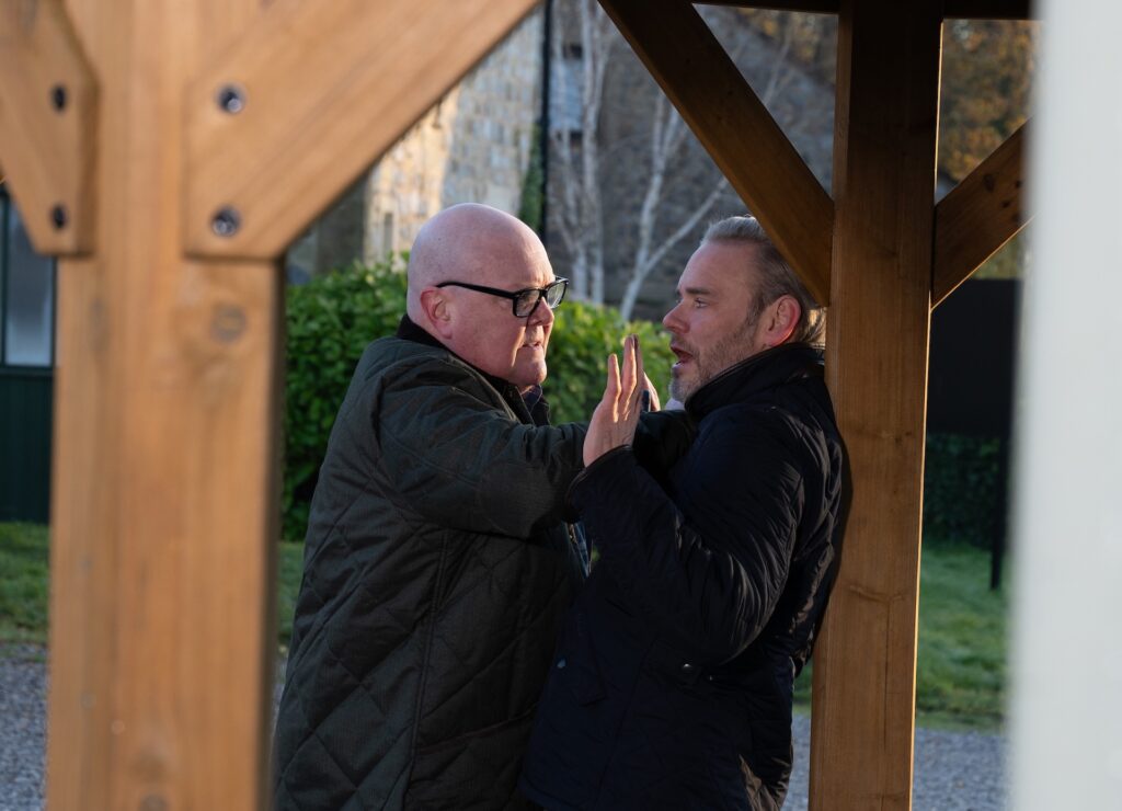 Paddy holds Ray up in Emmerdale