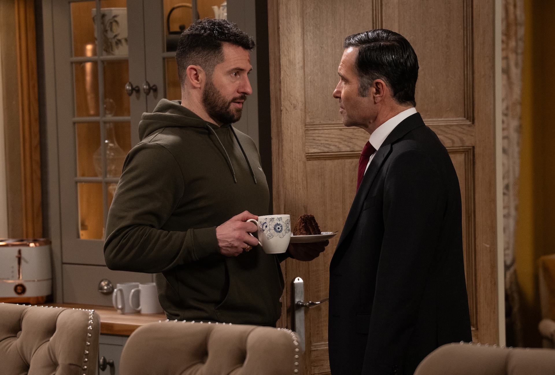 Ross gets his feet under the table at Home Farm (Credit: ITV)