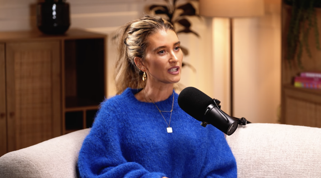 Charley Webb in blue jumper on podcast