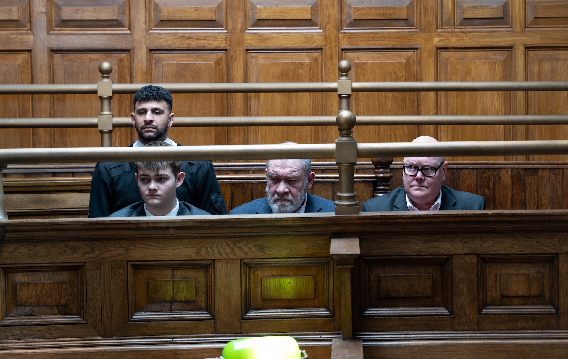 Dylan, Bear and Paddy sit listening to the cases being laid out (Credit: ITV)