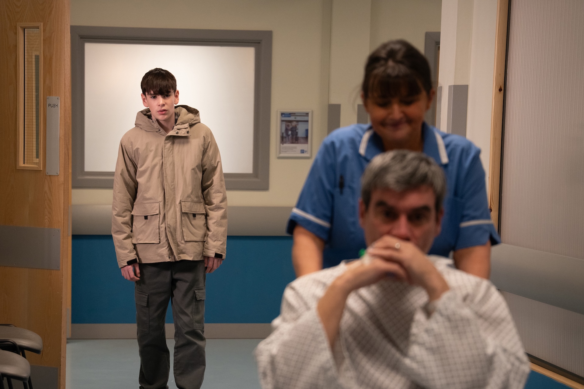 Cain is wheeled away as worried Kyle watches on (Credit: ITV)